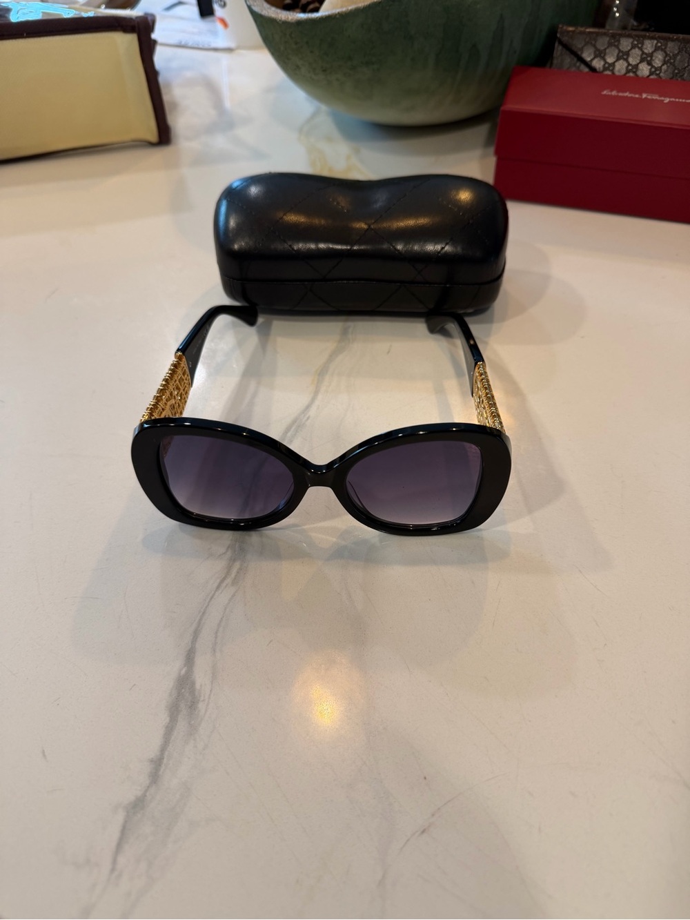 CHANEL Black Cat-Eye Sunglasses with Gold Chain Temples and Gray Gradient Lenses